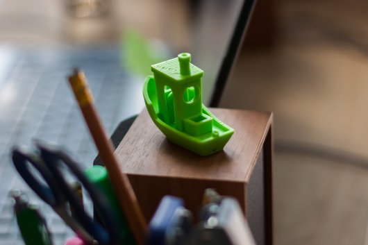 Miniature green plastic boat.