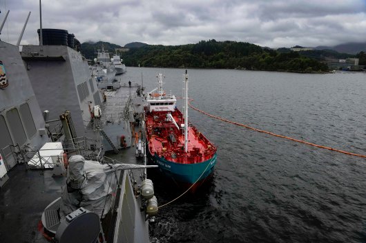 The guided-missile destroyer USS Oscar Austin receives fuel from the tanker Bergen Tank in Bergen, Norway, during a scheduled port visit on August 28, 2017.