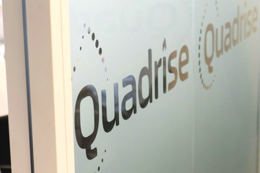 Quadrise Fuels International logo on frosted glass at the company's London office.
