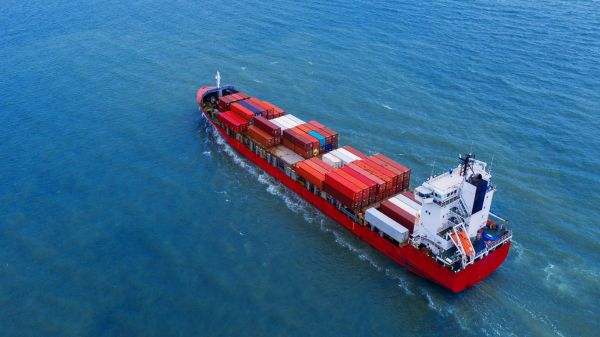 Photograph of a red container vessel.