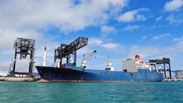 Photograph of a blue cargo vessel.