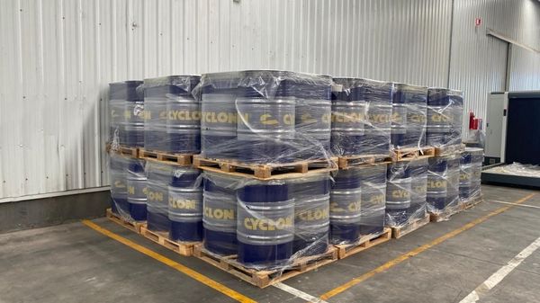 Cyclon lubricant drums stacked on pallets.