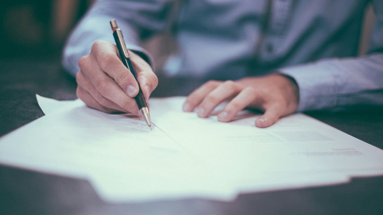 Person signing a document.
